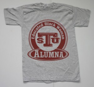 A t shirt that says tau alumna with the letters tau