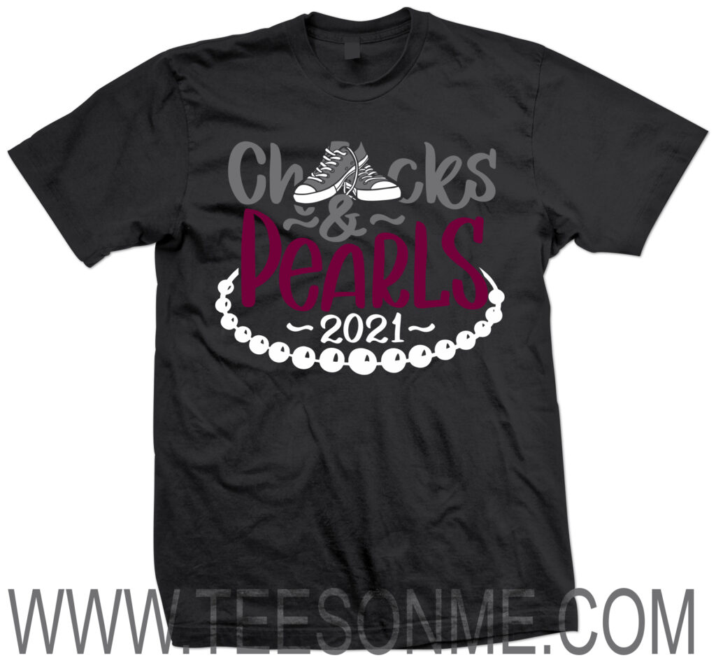 A black t shirt with shoes and pearls on it